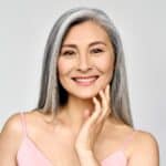 A woman smiling after full mouth restoration in Houston, TX