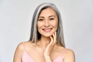 A woman smiling after full mouth restoration in Houston, TX